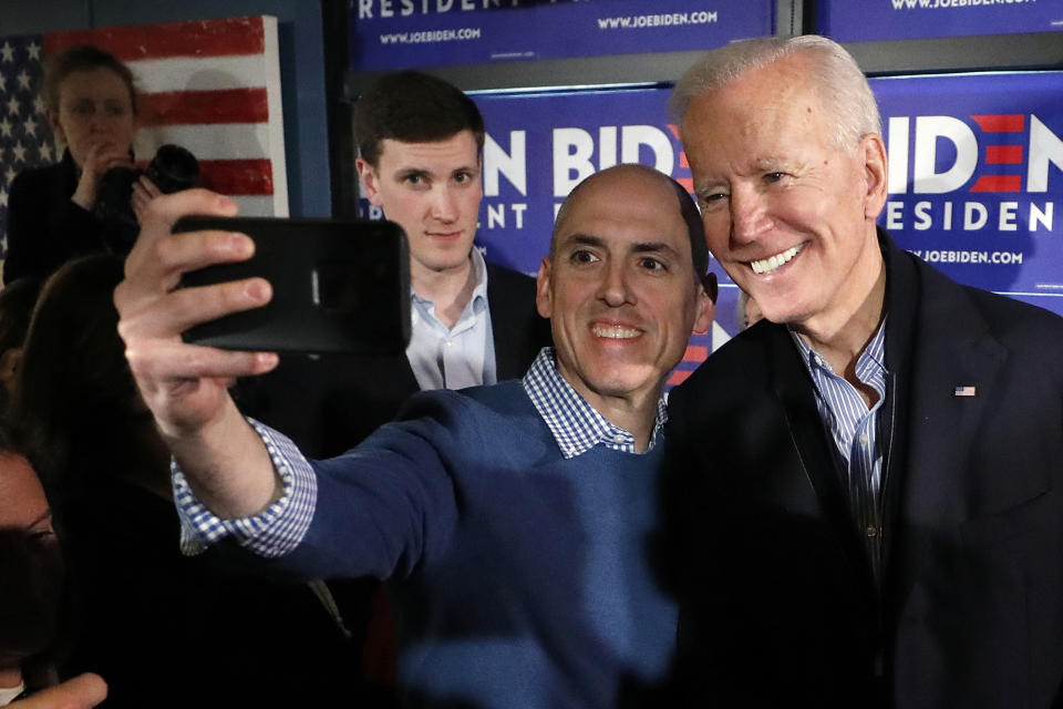 Former vice president and Democratic presidential candidate Joe Biden takes a selfie with a supporter during a campaign stop at the Community Oven restaurant in Hampton, N.H., Monday, May 13, 2019. (AP Photo/Michael Dwyer)