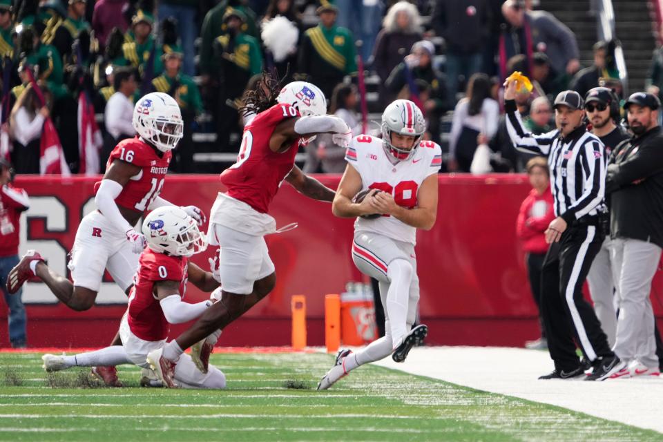 Rutgers defensive back Flip Dixon hits Ohio State punter Jesse Mirco shy of a Buckeyes first down.