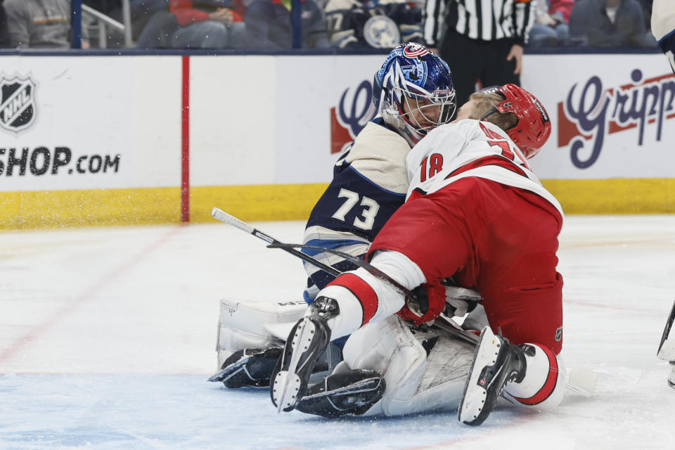Columbus Blue Jackets' Jet Greaves, left, and Carolina Hurricanes' Jack Drury collide in front of the net during the first period of an NHL hockey game Tuesday, April 16, 2024, in Columbus, Ohio. (AP Photo/Jay LaPrete)