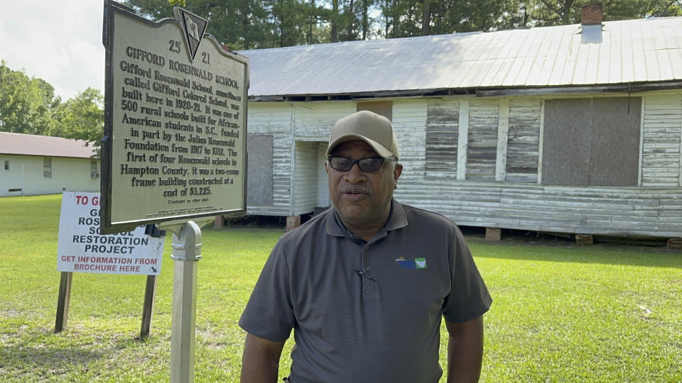 Pastor Charlie Grant speaks outside an old Rosenwald School he is trying to raise money to restore in Gifford, S.C., on Tuesday, July 11, 2023. Jewish businessman Julius Rosenwald donated money to help build 5,000 schools for Black students across the American South a century ago. (AP Photo/Jeffrey Collins)