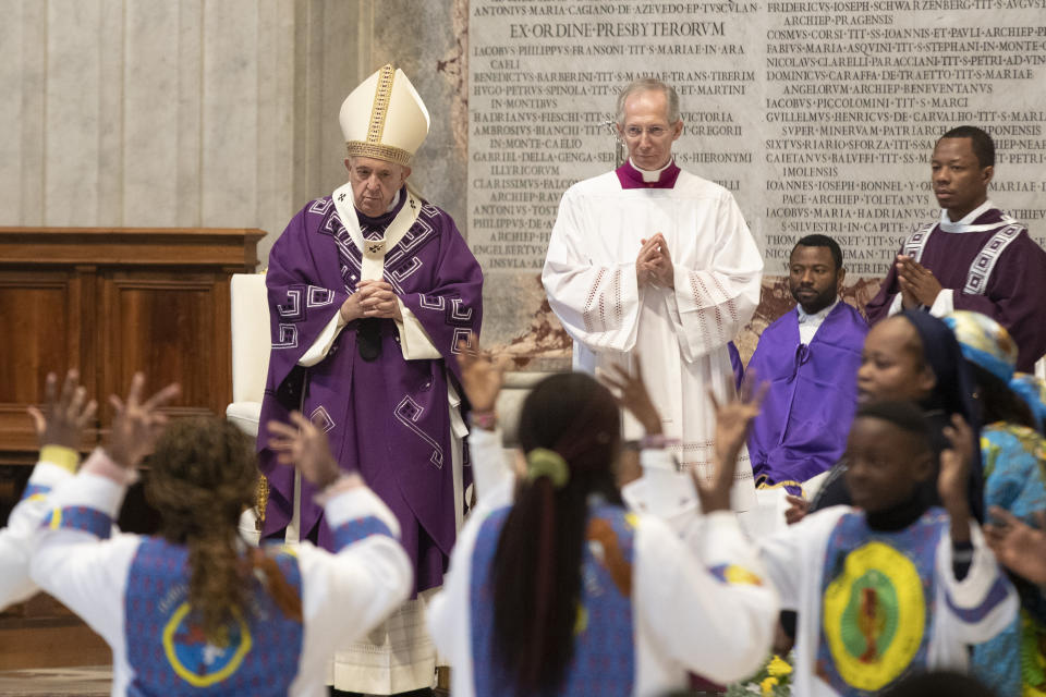 Faithful dance and sing in front of Pope Francis as he celebrates a Mass for the Congolese Catholic community of Rome in St. Peter's Basilica at the Vatican Sunday, Dec. 1, 2019. (AP Photo/Alessandra Tarantino)