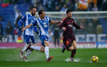 Soccer Football - La Liga Santander - Espanyol vs FC Barcelona - RCDE Stadium, Barcelona, Spain - February 4, 2018 Barcelona’s Lionel Messi in action with Espanyol’s Victor Sanchez REUTERS/Albert Gea