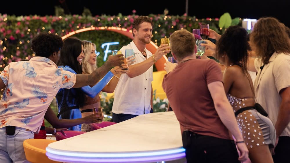  Love Island USA season 5 cast raising their glasses in a toast 