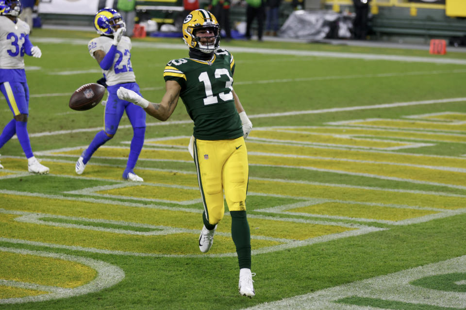 Green Bay Packers' Allen Lazard celebrates after a 58-yard touchdown run during the second half of an NFL divisional playoff football game against the Los Angeles Rams Saturday, Jan. 16, 2021, in Green Bay, Wis. (AP Photo/Matt Ludtke)