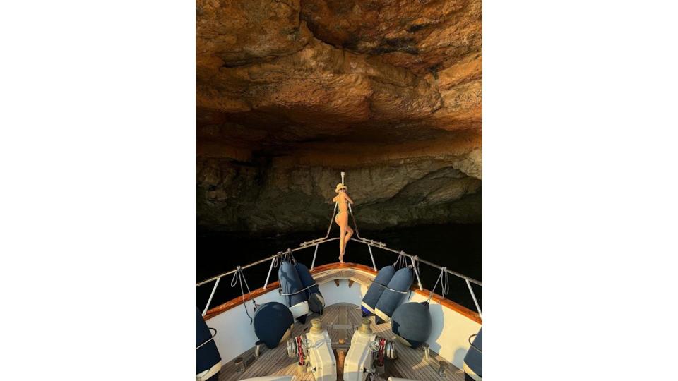 She took to the bow of a yacht in a glimmering golden bikini 