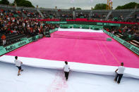 PARIS, FRANCE - JUNE 07: Groundstaff unveil a pink clay court prior to the women's legends doubles semi final match between Martina Navratilova of USA and Jana Novotna of Czech Republic and Nathalie Tauziat and Sandrine Testud of France during day 12 of the French Open at Roland Garros on June 7, 2012 in Paris, France. (Photo by Getty Images/Getty Images)