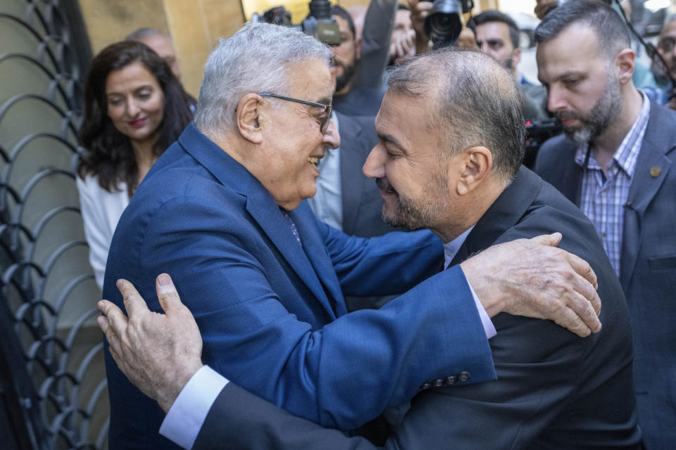 Lebanese Foreign Minister Abdallah Bouhabib, front left, welcomes his Iranian counterpart Hossein Amirabdollahian, front right, before their meeting in Beirut, Lebanon, Thursday, April 27, 2023. (AP Photo/Hassan Ammar)