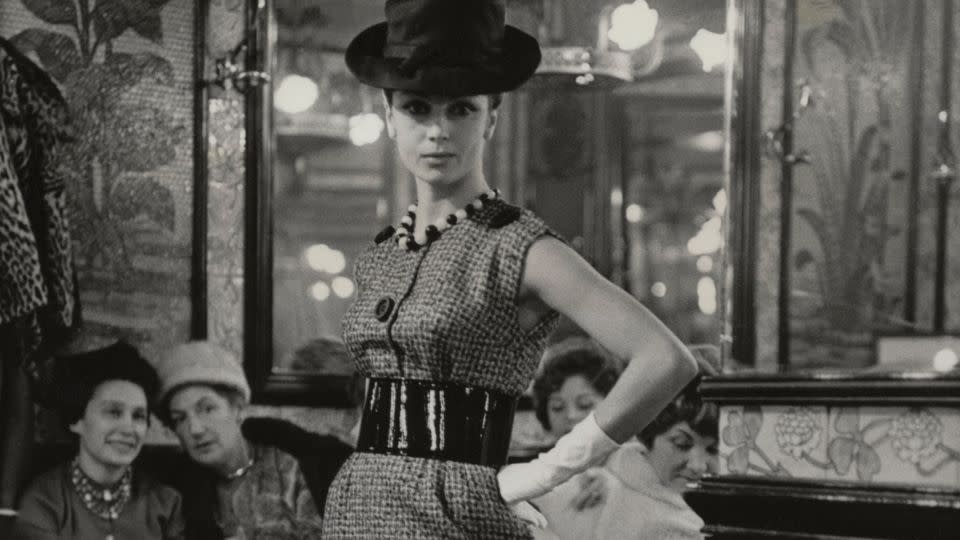 A model showcases a look from Chloé's Spring--Summer 1960 collection at the Brasserie Lipp in Paris on November 25, 1959. Courtesy Chloé Archive, Paris. - Chloé Archive