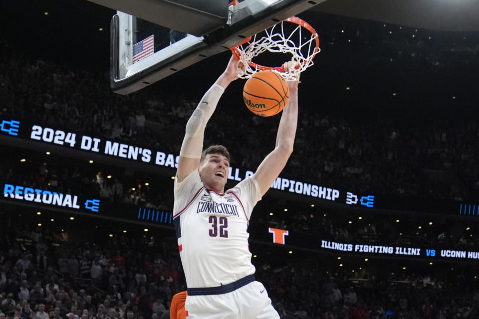 UConn center Donovan Clingan (32) dunks against Illinois during the first half of the Elite 8 college basketball game in the men's NCAA Tournament, Saturday, March 30, 2024, in Boston. (AP Photo/Steven Senne)