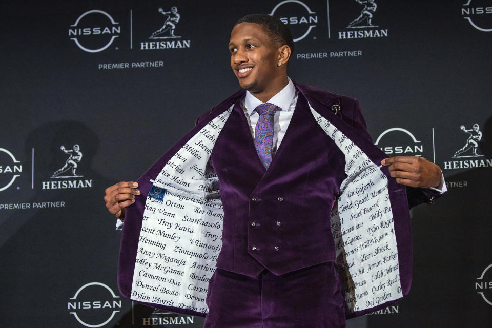 Washington quarterback Michael Penix Jr., a Heisman Trophy finalist, shows the inside of his jacket with his teammates' names at the end of a news conference before the award ceremony Saturday, Dec. 9, 2023, in New York. (AP Photo/Eduardo Munoz Alvarez)