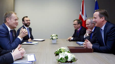 British Prime Minister David Cameron (R) and European Council President Donald Tusk attend a bilateral meeting ahead of a European Union leaders summit addressing the talks about the so-called Brexit and the migrants crisis, in Brussels, Belgium, February 18, 2016. REUTERS/Yves Herman