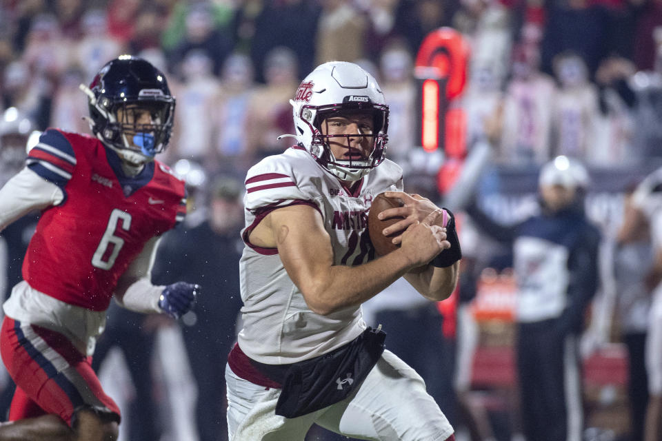 New Mexico State's Diego Pavia runs the ball against Liberty's Brandon Bishop during the first half of the Conference USA championship NCAA college football game Friday, Dec. 1, 2023, in Lynchburg, Va. (AP Photo/Robert Simmons)
