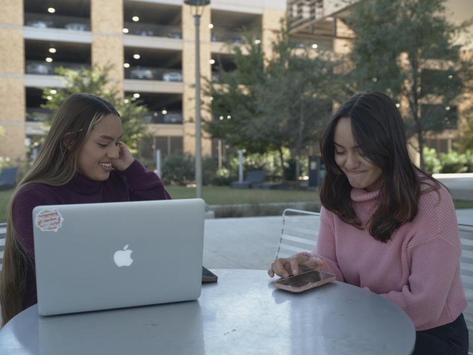 Twin sisters Judith Ortiz, left, and Janette Ortiz, right, study between classes