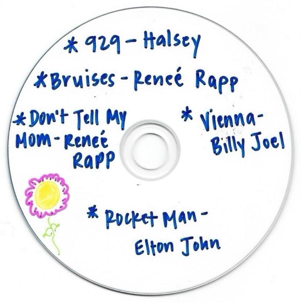 A handwritten CD with song titles from Halsey, Renée Rapp, Billy Joel, and Elton John