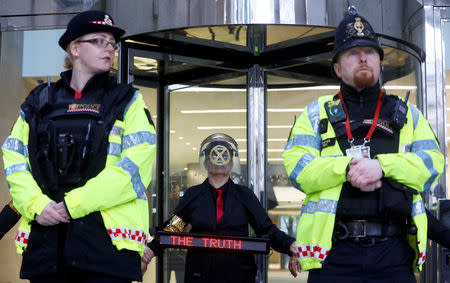 Police stands guard as demonstrators glue their hands to the London stock exchange during the Extinction Rebellion protest in London, Britain April 25, 2019. REUTERS/Simon Dawson