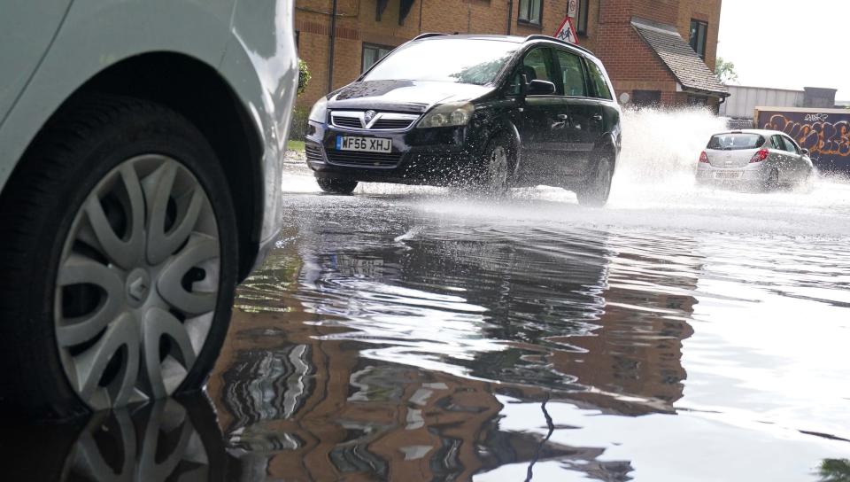 A car parked in a partially flooded road in Deptford, south-east London last week (PA/Yui Mok) (PA Wire)