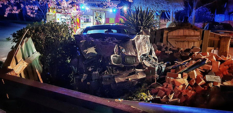 This BMW left a trail of destruction after smashing through walls and narrowly missing a home in Woodhurst, Cambridgeshire. (SWNS)