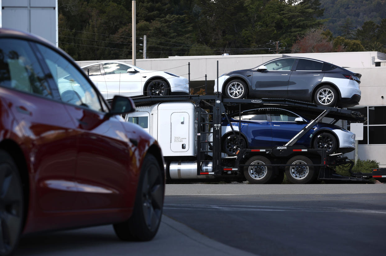 Brand new Tesla cars sit on a truck outside of a Tesla dealership on April 26, 2021 in Corte Madera, California. (Photo by Justin Sullivan/Getty Images)