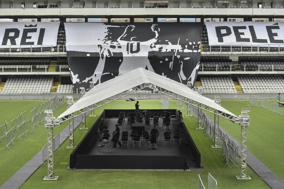 Workers prepare the staging area for the funeral of the late Brazilian soccer legend Pele on center field of the Vila Belmiro stadium, home of the Santos soccer club, in Santos, Brazil, Saturday, Dec. 31, 2022. Pele, who played most of his career with Santos, died in Sao Paulo on Thursday at the age of 82. (AP Photo/Matias Delacroix)