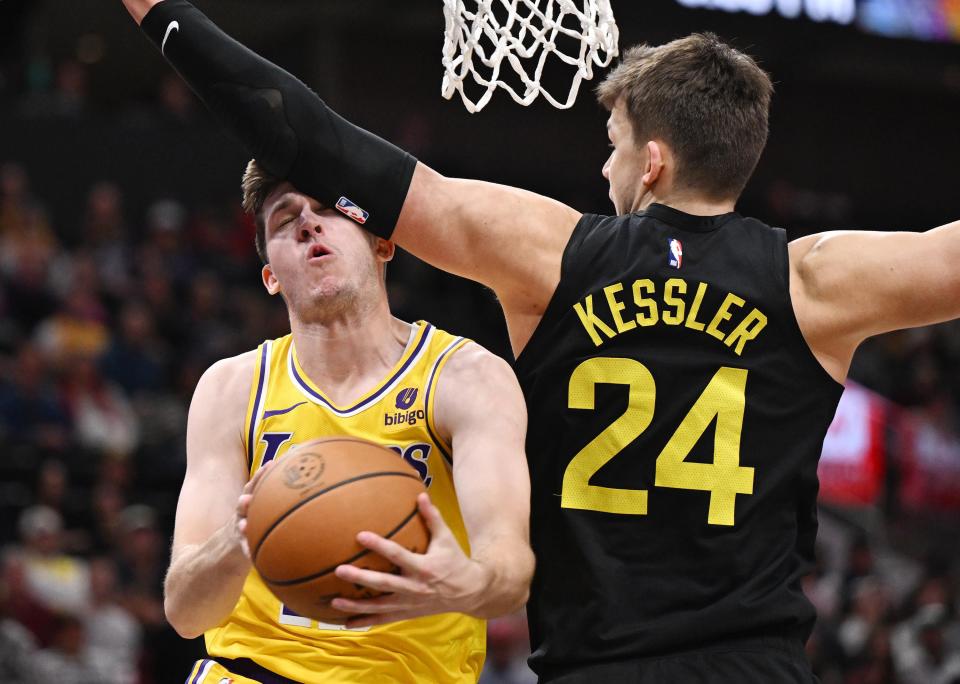 Los Angeles Lakers guard Austin Reaves (15) takes an arm to the head from Utah Jazz center Walker Kessler (24) as he drives to the hoop as the Utah Jazz and the Los Angeles Lakers play at the Delta Center in Salt Lake City on 2/14/24. LA won 138-122. | Scott G Winterton, Deseret News