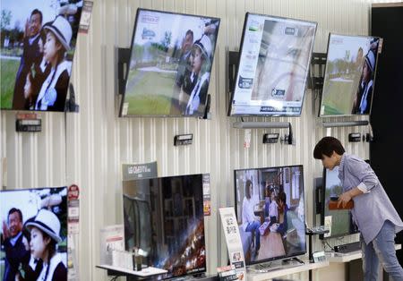 A woman looks at a LG Electronics' organic light-emitting diode (OLED) TV, which is made with LG Display flat screens, at its store in Seoul, South Korea, April 26, 2016. REUTERS/Kim Hong-Ji/File Photo