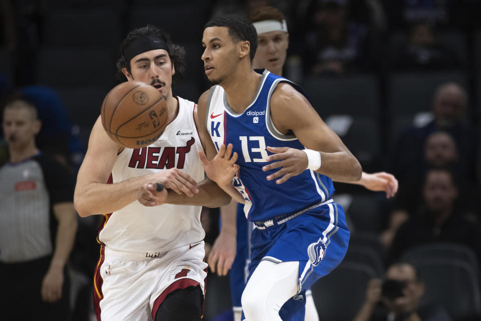 Miami Heat guard Jaime Jaquez Jr., left, slaps the ball away from Sacramento Kings forward Keegan Murray (13) in the first quarter of an NBA basketball game in Sacramento, Calif., Monday, Feb. 26, 2024. (AP Photo/José Luis Villegas)