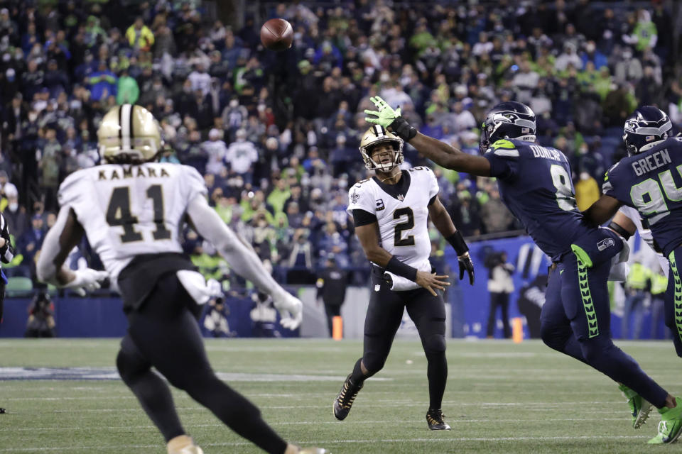 New Orleans Saints quarterback Jameis Winston (2) passes to running back Alvin Kamara (41) for a touchdown against the Seattle Seahawks during the first half of an NFL football game, Monday, Oct. 25, 2021, in Seattle. (AP Photo/John Froschauer)