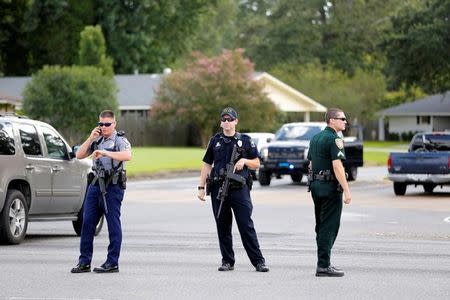 Police officers block off a road after a shooting of police in Baton Rouge, Louisiana, U.S. July 17, 2016. REUTERS/Joe Penney