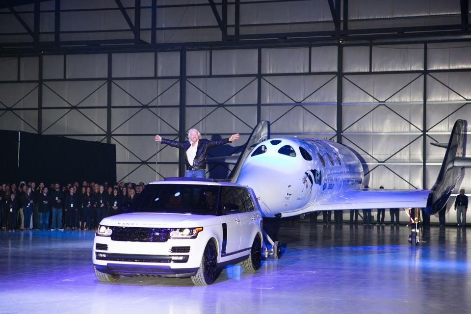 Virgin Group founder Richard Branson stands before Virgin Spaceship Unity, otherwise known as SpaceShipTwo, during its unveiling at the company's Mojave, California, headquarters in 2016. VSS Unity is built by Virgin-owned The Spaceship Company, and is a new craft designed in the wake of a 2014 flight in which a pilot died.
