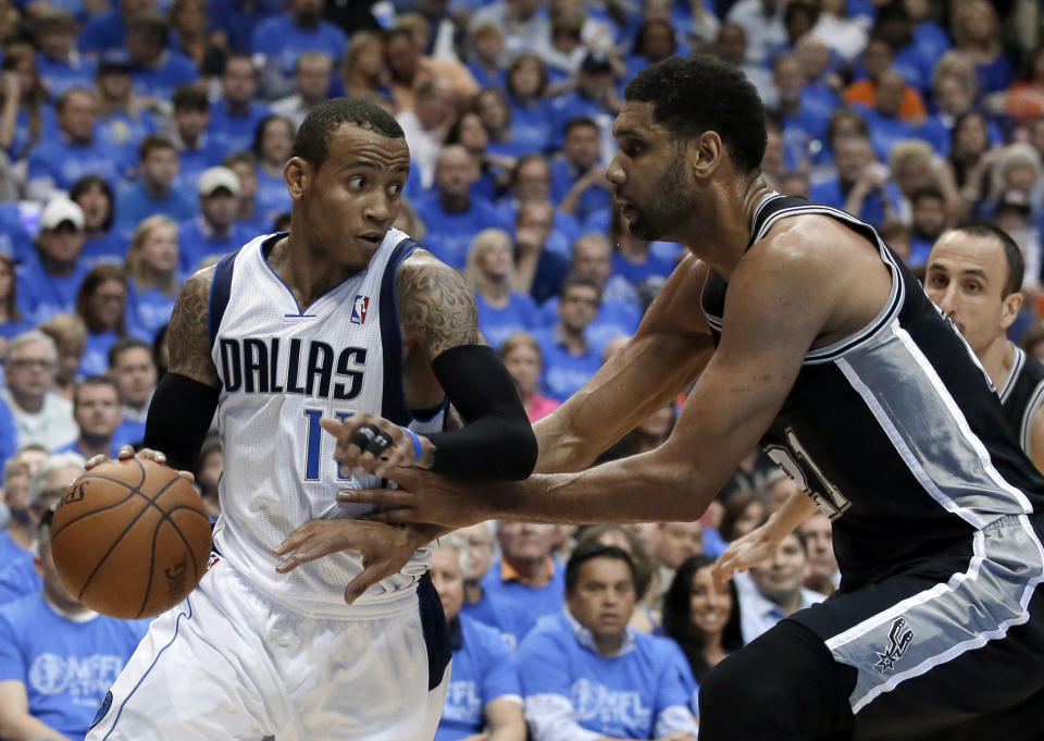 Dallas Mavericks' Monta Ellis (11) looks for an opening to the basket as San Antonio Spurs' Tim Duncan defends in the first half of Game 4 of an NBA basketball first-round playoff series, Monday, April 28, 2014, in Dallas. (AP Photo/Tony Gutierrez)