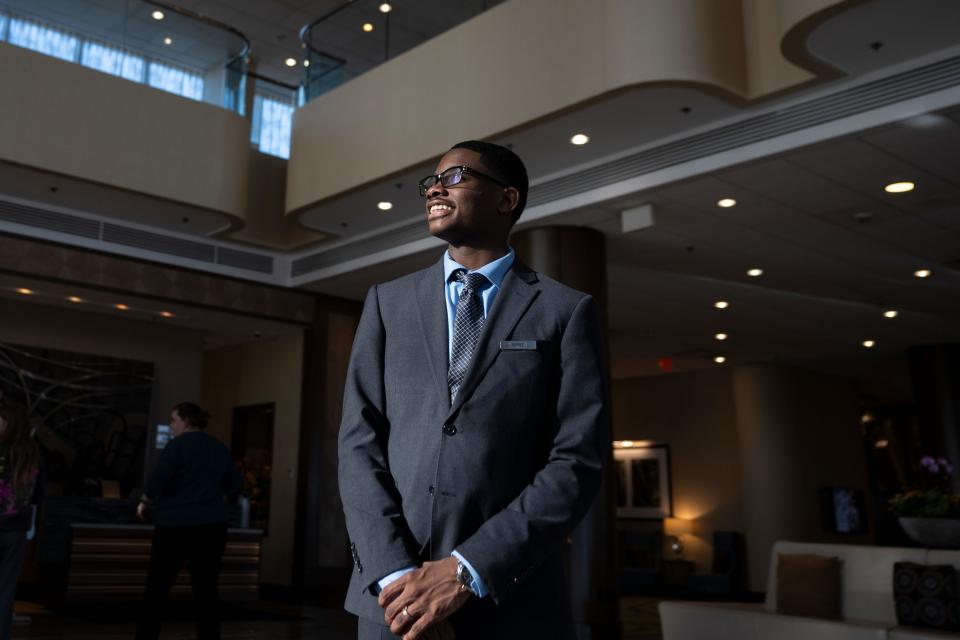 Mar 29, 2024; Teaneck, N.J., United States; Alfred Lewis, 17, is a senior at Teaneck High School and works at the Glenpointe Marriott as part of a paid work-study program. Lewis poses for a photo in the lobby between checking in customers.