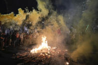 Israelis opposed to Prime Minister Benjamin Netanyahu's judicial overhaul plan set up bonfires and block a highway during a protest moments after the Israeli leader fired his defense minister, in Tel Aviv, Israel, Sunday, March 26, 2023. Defense Minister Yoav Gallant had called on Netanyahu to freeze the plan, citing deep divisions in the country and turmoil in the military. (AP Photo/Ohad Zwigenberg)