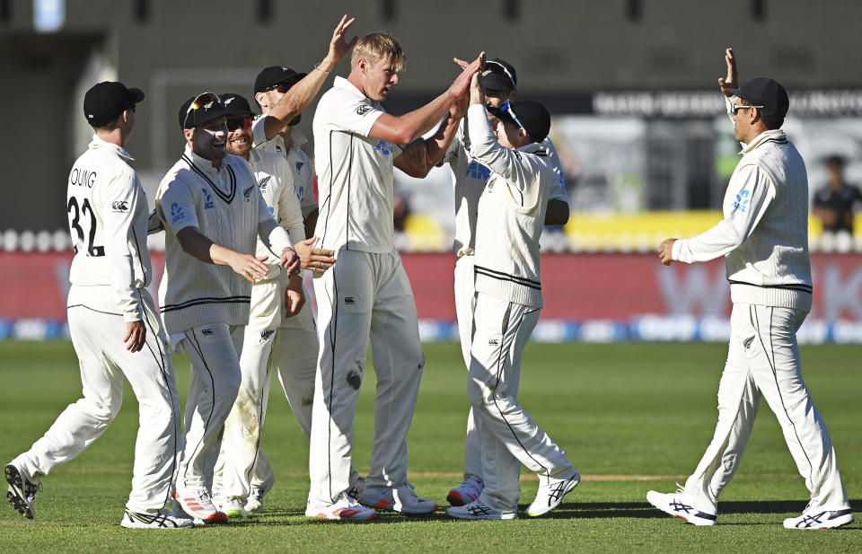 New Zealand's Kyle Jamieson, center celebrates with teammates after taking the wicket of the West Indies' Alzarri Joseph during play on the second day of their second cricket test at Basin Reserve in Wellington, New Zealand, Saturday, Dec. 12, 2020. (Andrew Cornaga/Photosport via AP)