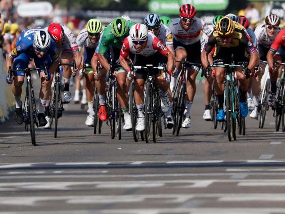 Caleb Ewan, centre, speeds to victory on stage 16 in Nimes (EPA)