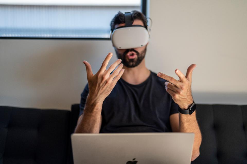 Gavin Menichini, using the Oculus Quest 2 VR headset, gives a demonstration of the Immersed Virtual Reality program which can be used for many applications including virtual meetings at the Immersed offices on January 28, 2022 in Austin, Texas. - While still the stuff of science fiction for most people, forerunners of the metaverse vision for the internet's future are already de rigueur for handfuls of people beyond the gamer and techno-hipster crowds. (Photo by Sergio FLORES / AFP) (Photo by SERGIO FLORES/AFP via Getty Images)