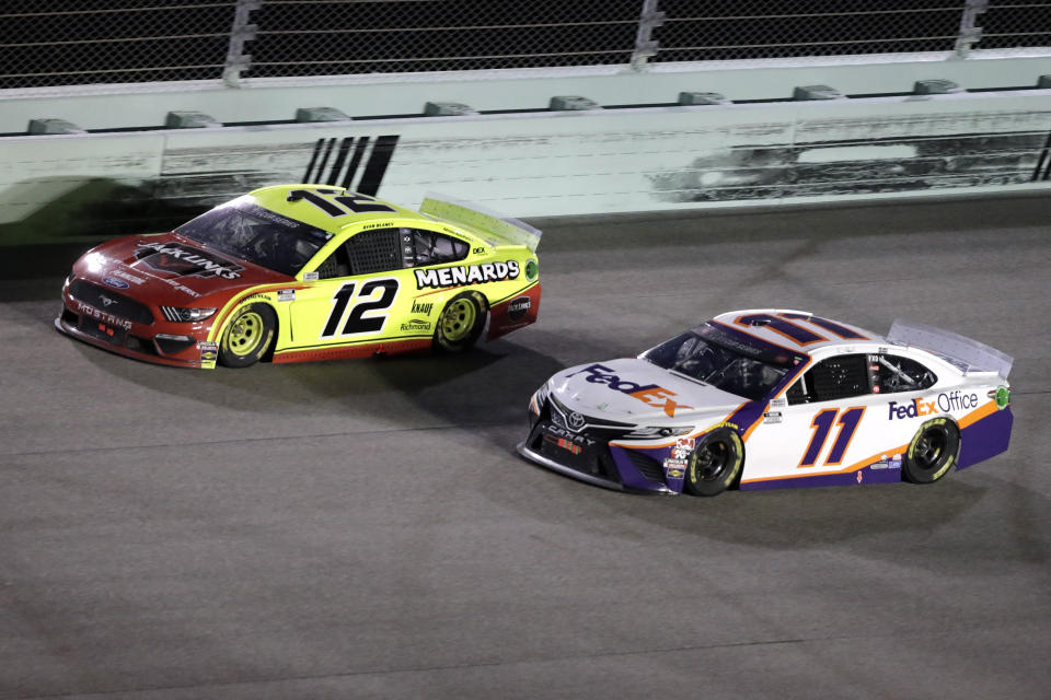 Ryan Blaney (12) and Denny Hamlin (11) battle for the lead during a NASCAR Cup Series auto race Sunday, June 14, 2020, in Homestead, Fla. (AP Photo/Wilfredo Lee)