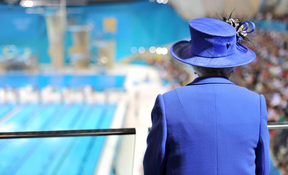 LONDON, UNITED KINGDOM - JULY 28: Queen Elizabeth II watches the morning session of the swimming at the Aquatics Centre during a tour of the Olympic Park on day one of the London 2012 Olympics Games on July 28, 2012 in London, England. (Photo by Martin Rickett/WPA Pool/Getty Images)