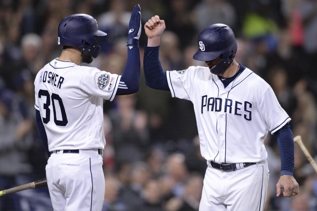 San Diego Padres' Wil Myers is congratulated by Eric Hosmer after hitting a home run during the seventh inning of a baseball game against the Arizona Diamondbacks Tuesday, April 2, 2019, in San Diego. (AP Photo/Orlando Ramirez)