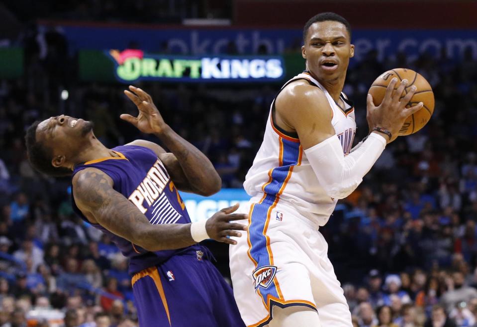 Phoenix Suns guard Eric Bledsoe, left, falls backwards following an offensive foul by Oklahoma City Thunder guard Russell Westbrook, right, in the second quarter of an NBA basketball game in Oklahoma City, Saturday, Dec. 17, 2016. (AP Photo/Sue Ogrocki)