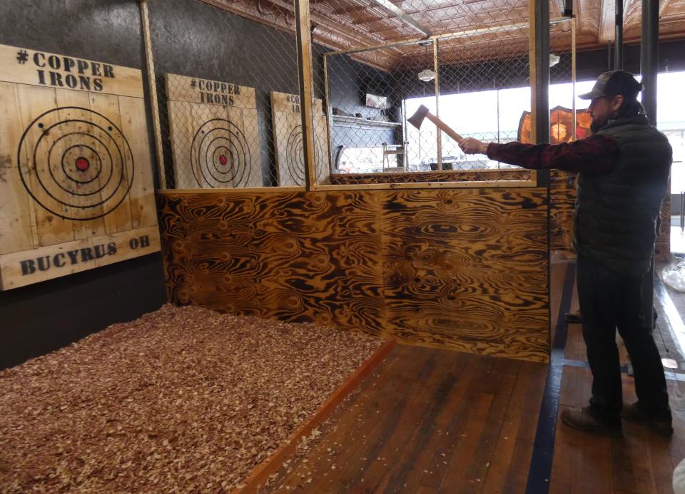 Co-owner Steve Knapp demonstrates his axe-throwing technique at The Copper Irons, 215 S. Sandusky Ave.