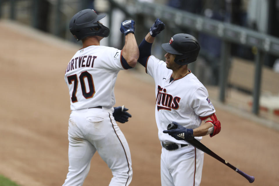 Minnesota Twins' Ben Rortvedt (7) high fives teammate Andrelton Simmons (9) after hitting a home run against the Kansas City Royals during the second inning of a baseball game Sunday, May 30, 2021, in Minneapolis. (AP Photo/Stacy Bengs)