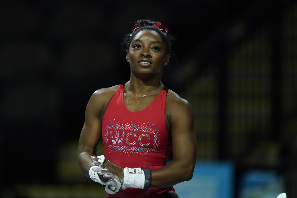 Simone Biles, a seven-time Olympic medalist and the 2016 Olympic champion, practices performs on the uneven bars at the U.S. Classic gymnastics competition Friday, Aug. 4, 2023, in Hoffman Estates, Ill. (AP Photo/Morry Gash)