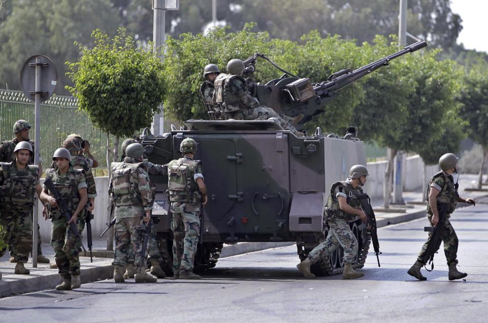 FILE -- In this Oct. 22, 2012, file photo, Lebanese Army soldiers deploy after overnight clashes between Sunni and Shiite gunmen in Beirut, Lebanon. From radical preachers to irreverent taxi drivers, anger is spreading through Lebanon’s Sunni community toward the country’s military, adding a dangerous twist to Lebanon’s instability, already shaken by relentless bombings. Many Sunnis accuse the military of siding with their rivals, the powerful Shiite group Hezbollah, as sectarian tensions grow in Lebanon, stoked by the civil war in neighboring Syria. (AP Photo/Hussein Malla, File)