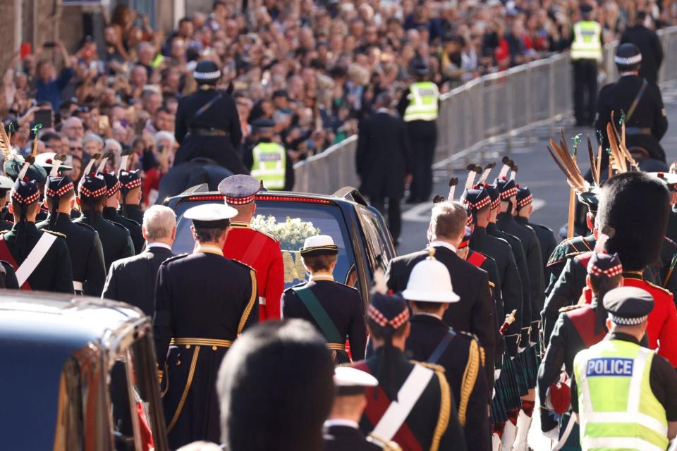 Britain's Prince Andrew, Duke of York, Britain's Princess Anne, Princess Royal and Britain's King Charles III (obscured) walk behind the procession of Queen Elizabeth II's coffin, from the Palace of Holyroodhouse to St Giles Cathedral, on the Royal Mile on September 12, 2022, where Queen Elizabeth II will lie at rest. - Mourners will on Monday get the first opportunity to pay respects before the coffin of Queen Elizabeth II, as it lies in an Edinburgh cathedral where King Charles III will preside over a vigil. (Photo by Odd ANDERSEN / POOL / AFP) (Photo by ODD ANDERSEN/POOL/AFP via Getty Images)