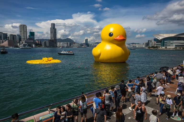 People visit the "Double Ducks" by Dutch artist Florentijn Hofman after one of the birds was deflated at Victoria Harbour in Hong Kong (DALE DE LA REY)