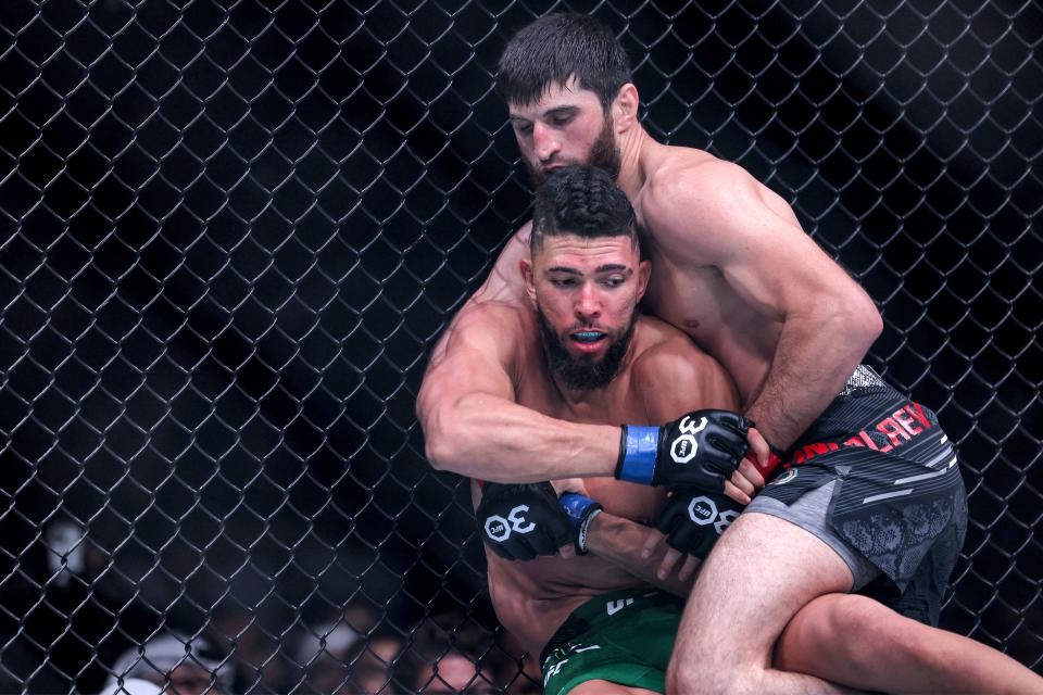 Russia’s Magomed Ankalaev (black) and Brazil’s Johnny Walker (green) compete in their Light Heavyweight bout during the Ultimate Fighting Championship 294 (UFC) event at the Etihad Arena in Abu Dhabi on October 21, 2023. (Photo by Giuseppe CACACE / AFP) (Photo by GIUSEPPE CACACE/AFP via Getty Images)