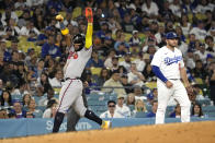 Atlanta Braves' Ronald Acuna Jr., left, celebrates after stealing third as Los Angeles Dodgers third baseman Max Muncy stands by during the fifth inning of a baseball game Friday, Sept. 1, 2023, in Los Angeles. (AP Photo/Mark J. Terrill)
