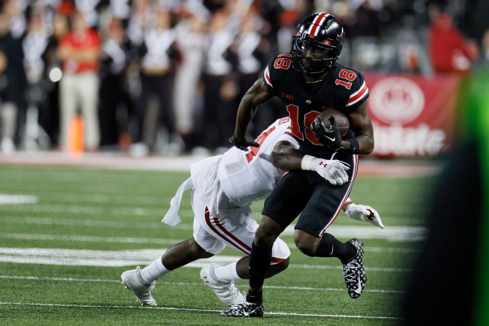 Ohio State receiver Marvin Harrison (18) tries to get away from Wisconsin linebacker Jordan Turner during the first half of an NCAA college football game Saturday, Sept. 24, 2022, in Columbus, Ohio. (AP Photo/Jay LaPrete)