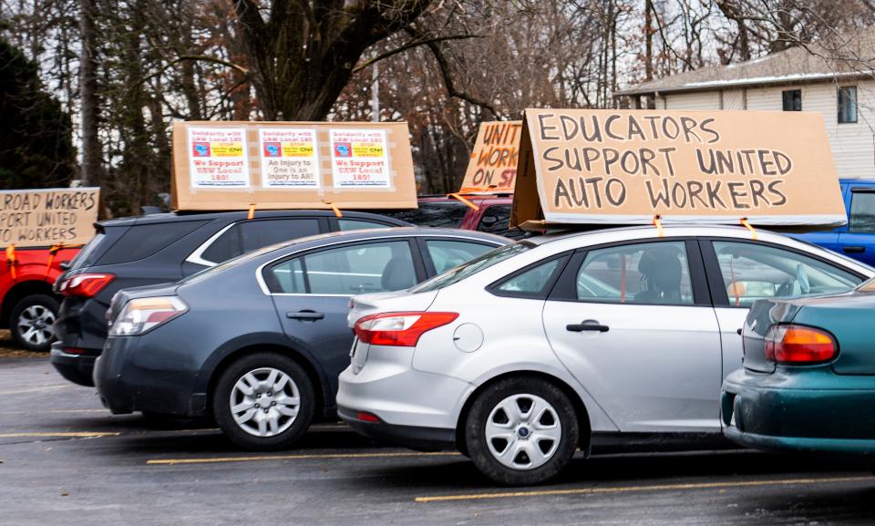 Union members put signs on top of their cars for a rally in support of the CNH Industrial workers who are currently on strike.