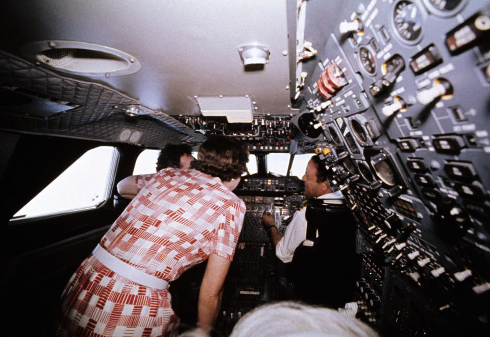 Queen Elizabeth II visiting the flight deck during her flight home from Bridgetown, Barbados, in the supersonic Concorde after her Silver Jubilee tour of Canada and the West Indies.